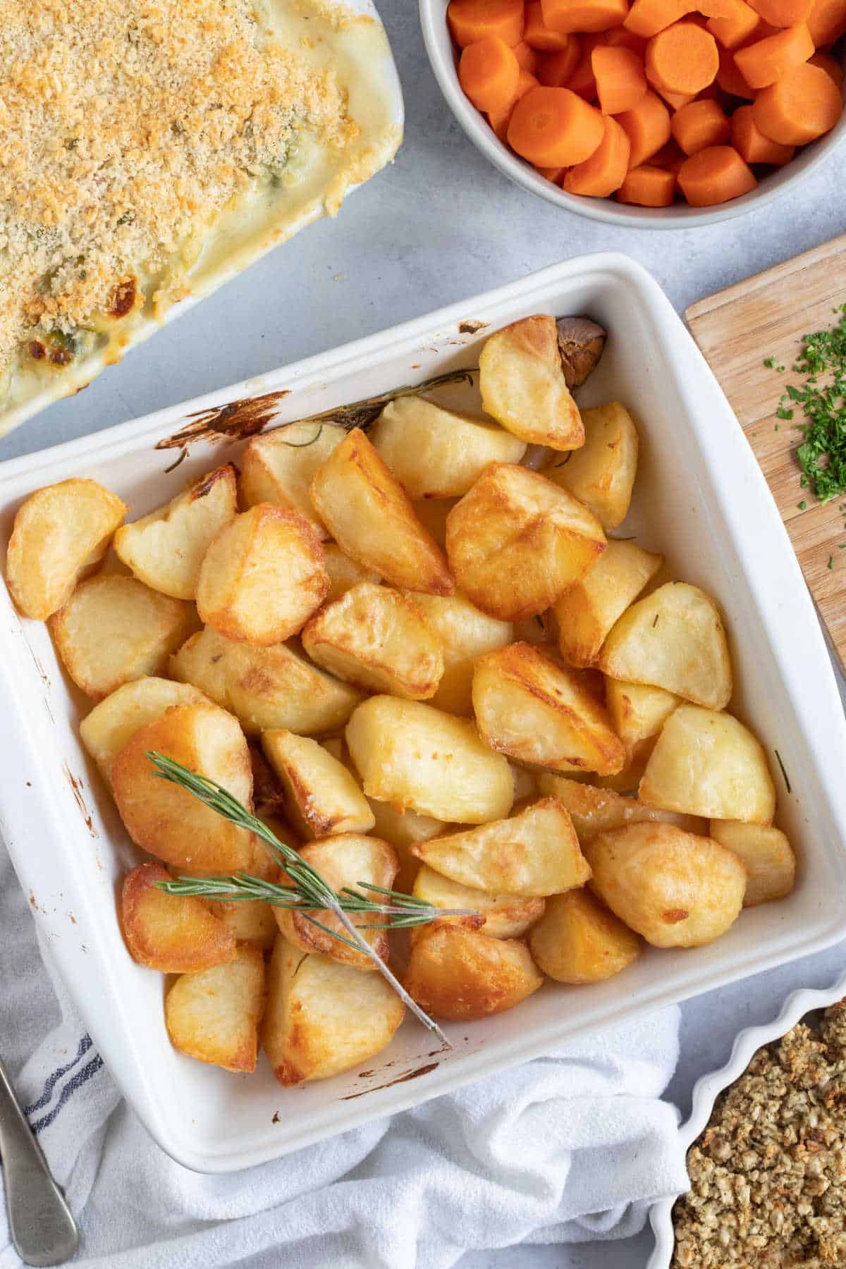 Duck fat roasted potatoes in a white serving dish.