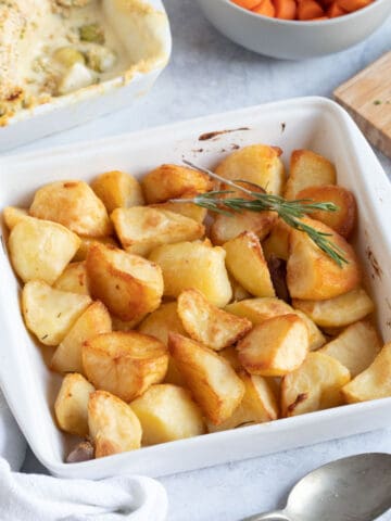 Duck fat roast potatoes in a white dish.