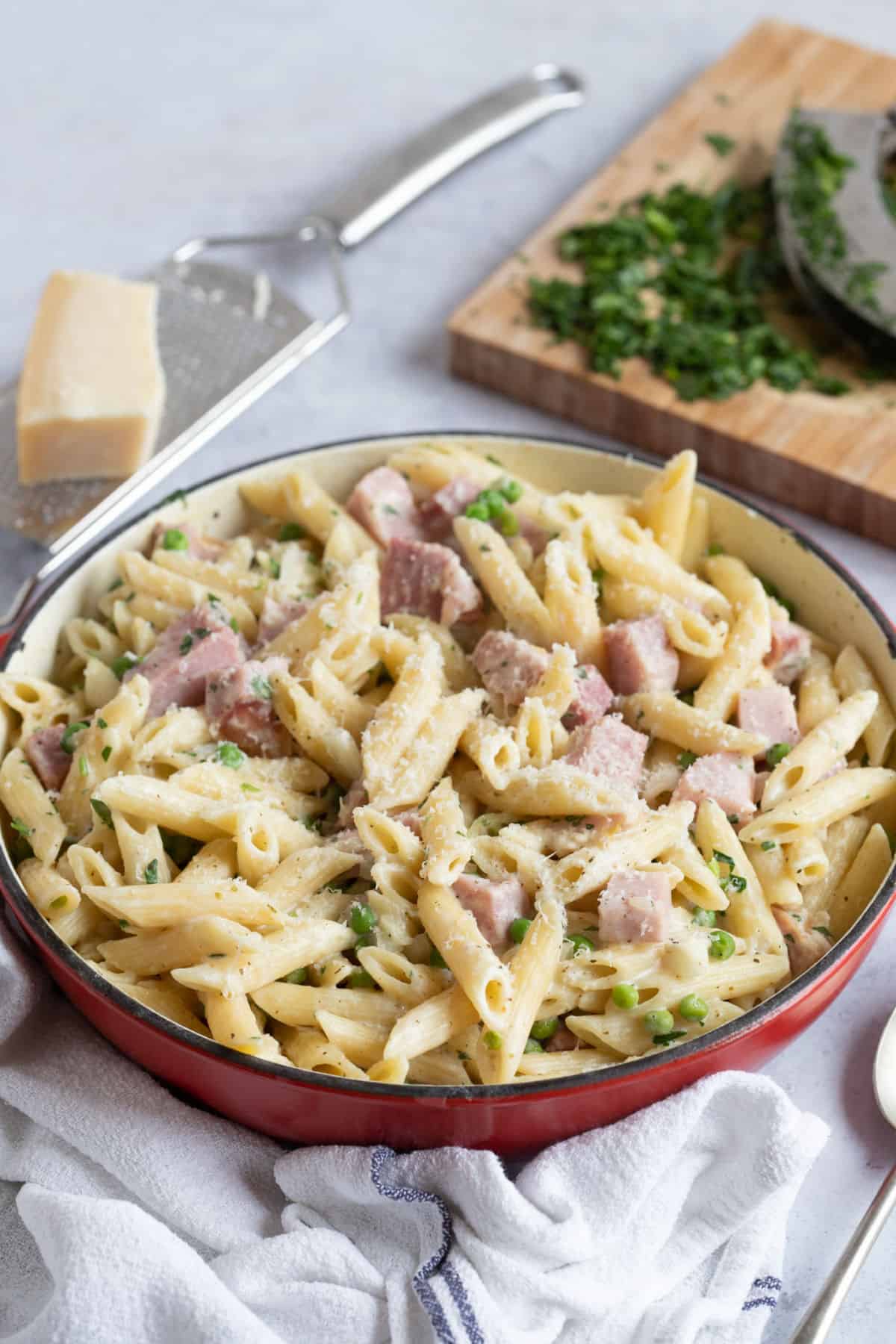 Leftover ham and pea pasta in a red pan.
