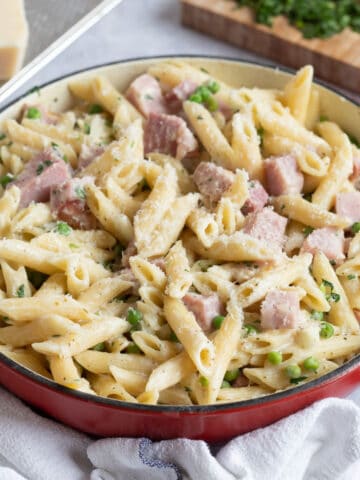 Gammon ham pasta in a red pan.