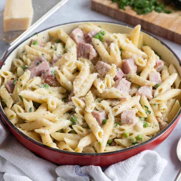 Gammon ham pasta in a red pan.