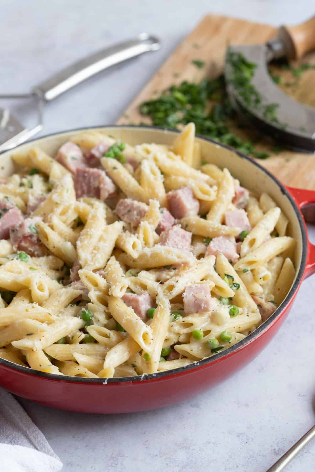 Leftover ham and pea pasta in a red pan.