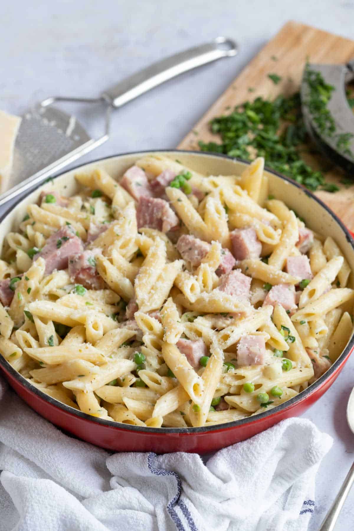 Creamy leftover gammon pasta and peas in a pan.