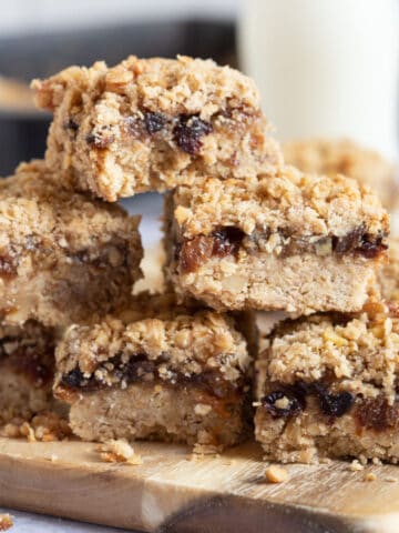 A stack of mincemeat crumble slices on a wooden board.