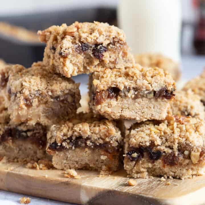 A stack of mincemeat crumble slices on a wooden board.