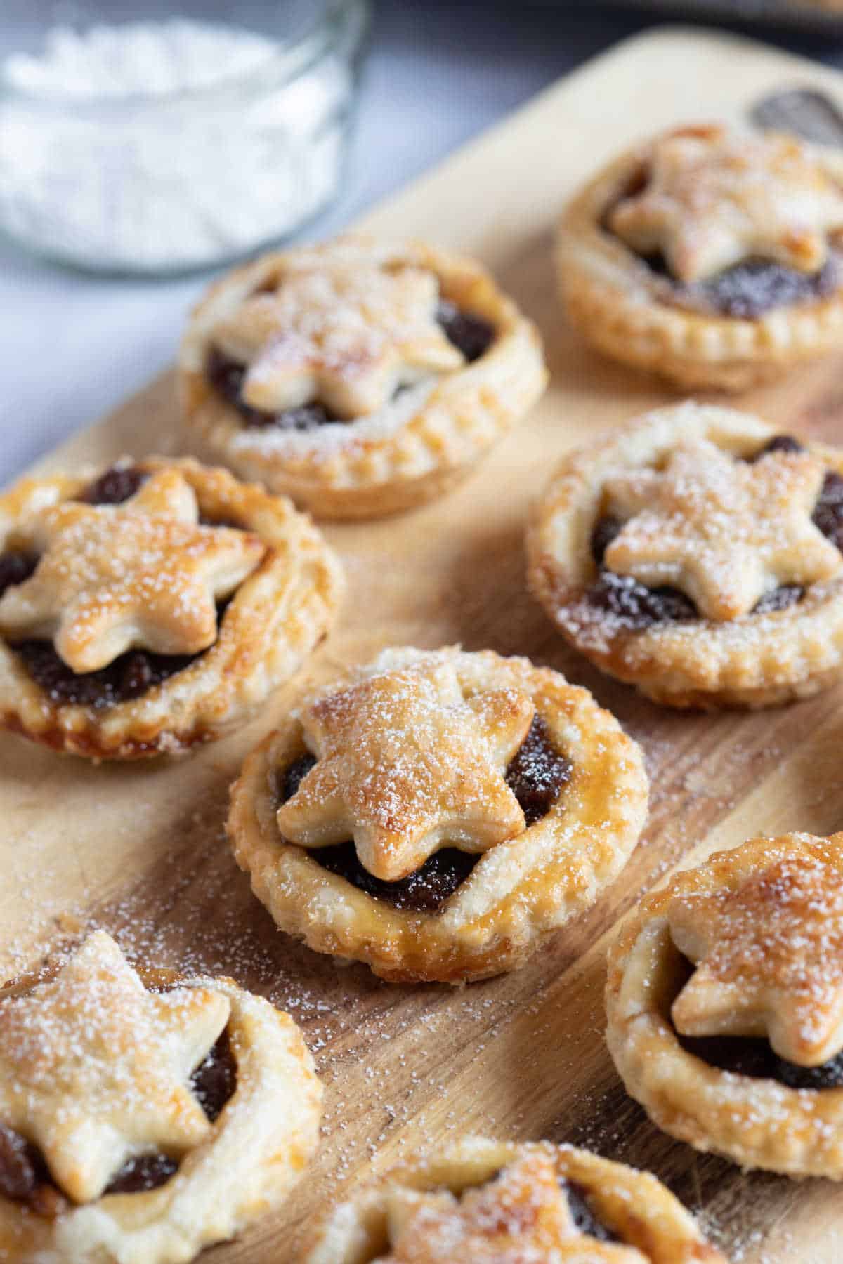 Puff pastry mince pies dusted with icing sugar.
