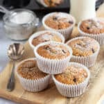 Stollen muffins on a wooden board dusted with icing sugar.