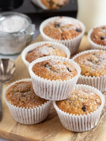 Stollen muffins on a wooden board dusted with icing sugar.