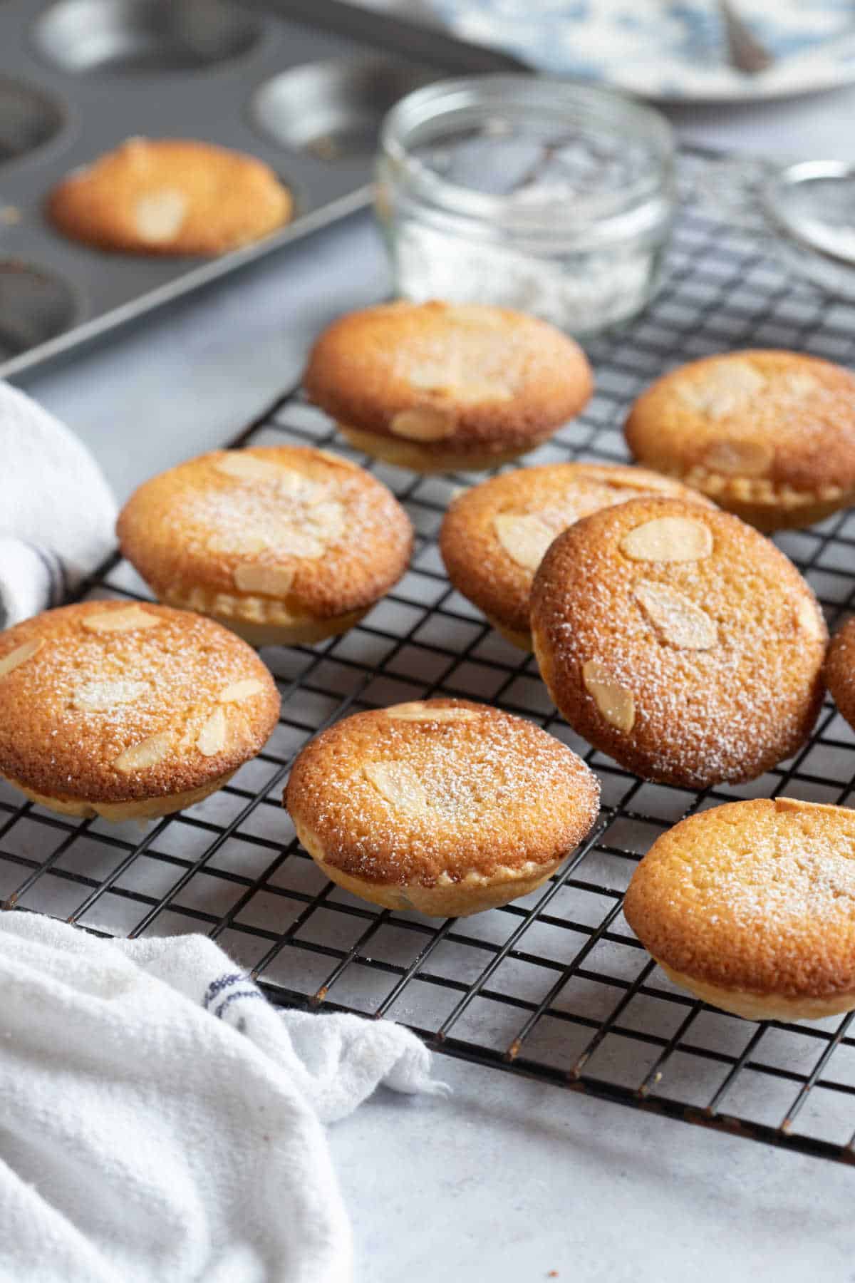 Almond topped mince pies on a wire rack.