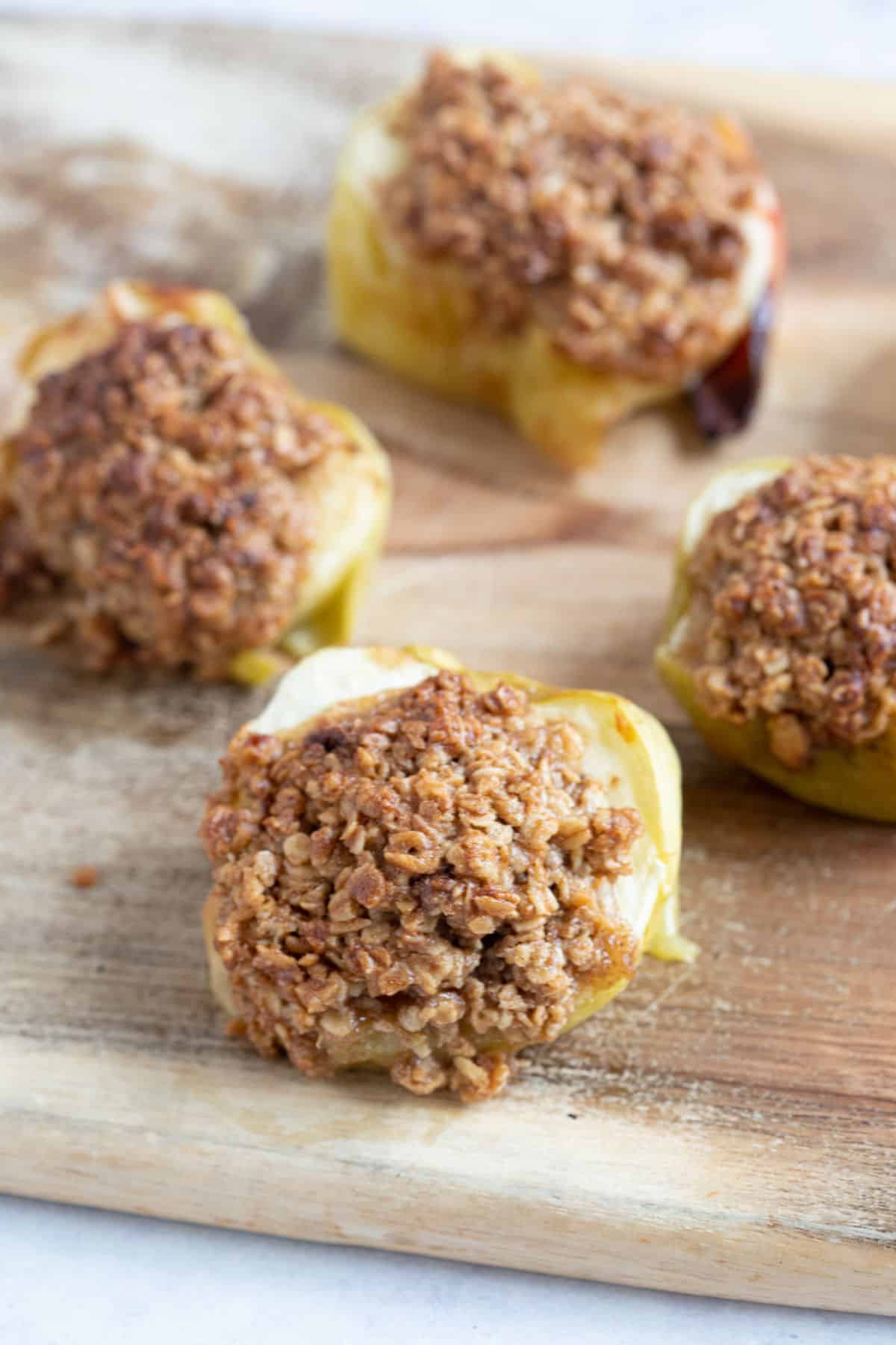 Air fryer baked apples on a wooden board.