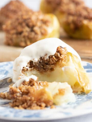 Baked apple on a blue and white plate.