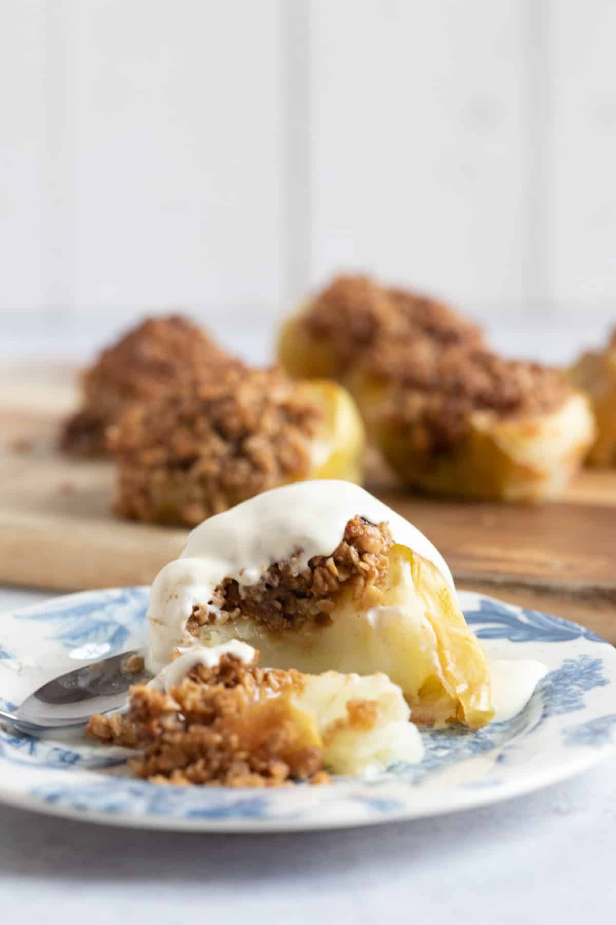 Baked apple on a plate with a crumble topping.
