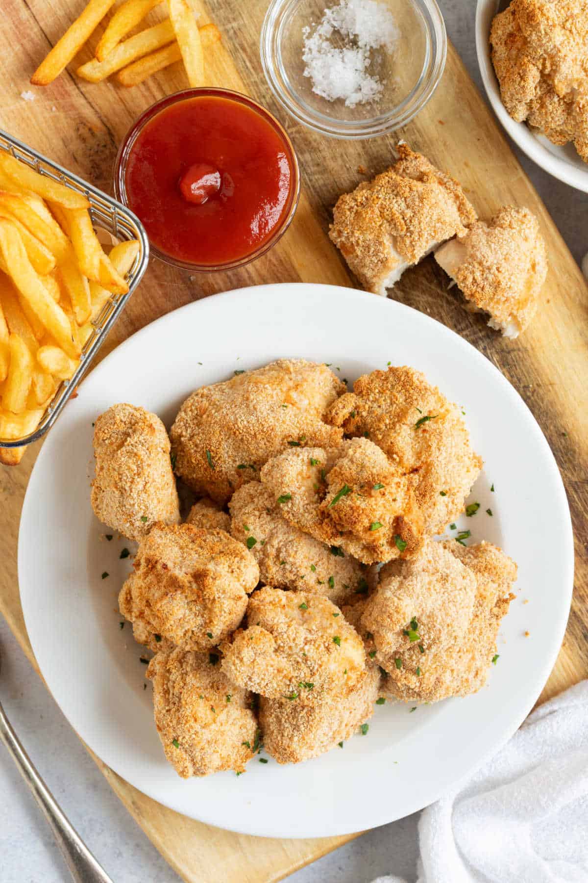 Air fryer chicken nuggets on a white plate.