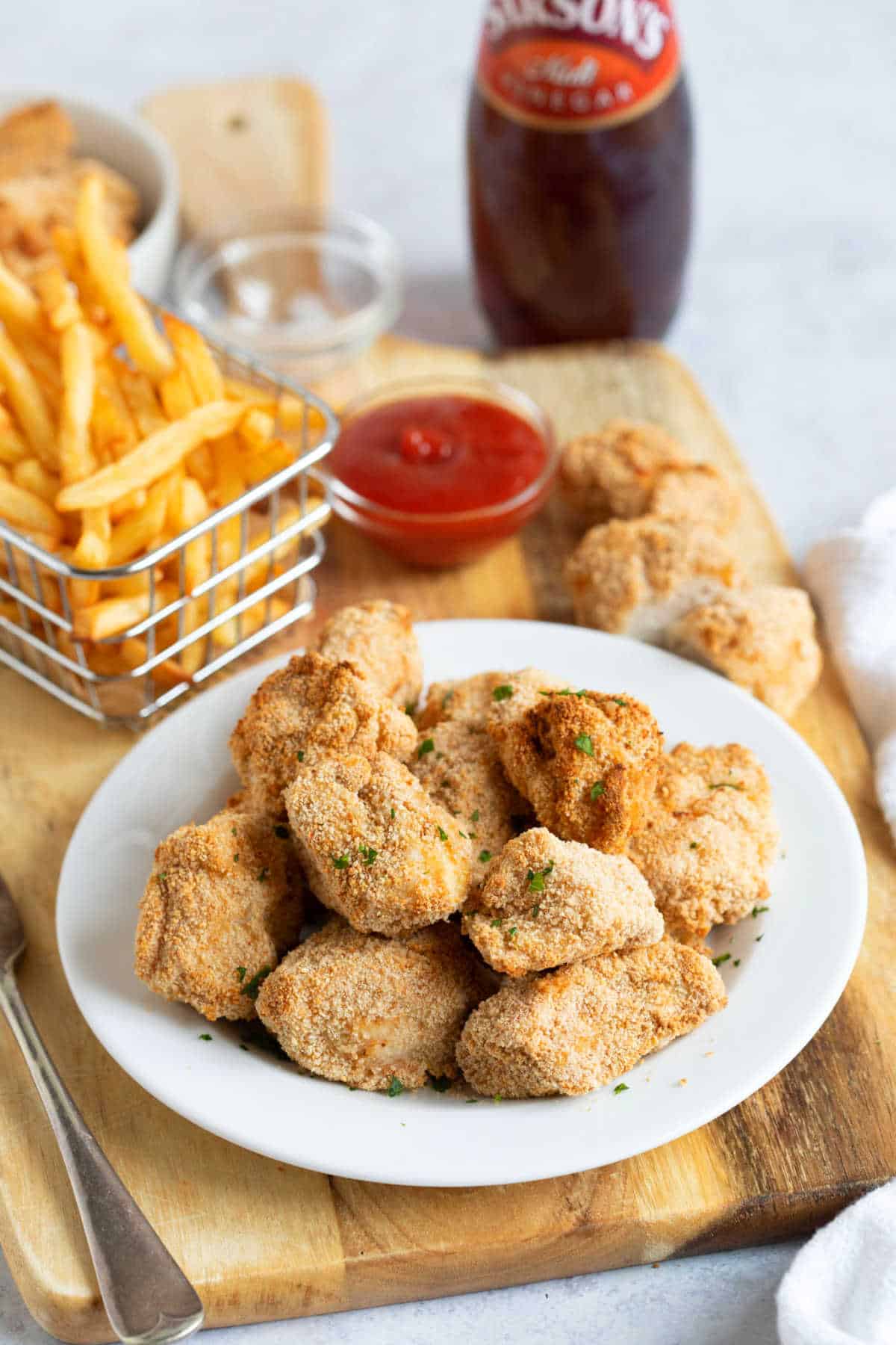 Air fryer chicken nuggets on a white plate.