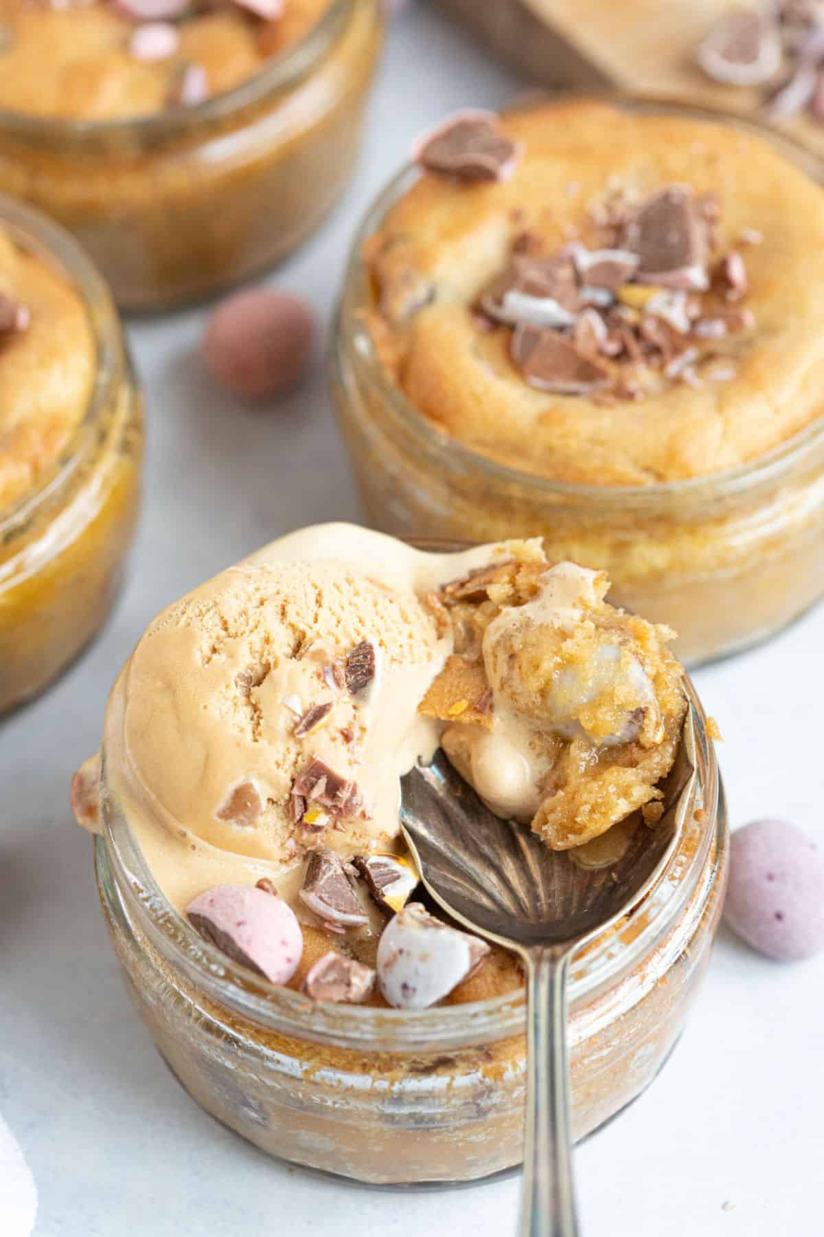 Air fried mini egg cookie dough desserts in individual glass ramekins.