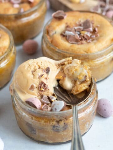 Air fryer mini egg dessert pots with a scoop of ice cream on top.