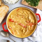 Leftover chicken curry in apna with rice and naan bread on the side.