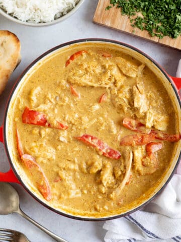 Leftover chicken curry in apna with rice and naan bread on the side.