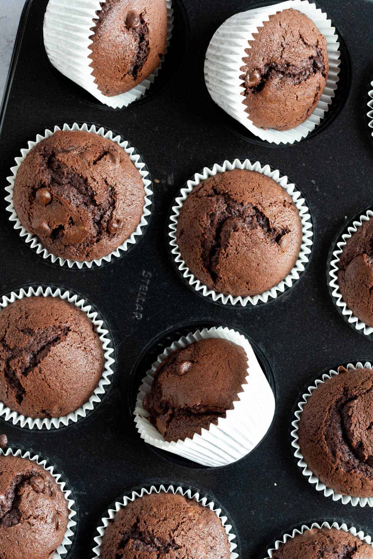 Chocolate nutella muffins in a muffin tin.