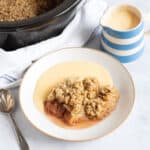 Slow cooker apple crumble with custard.