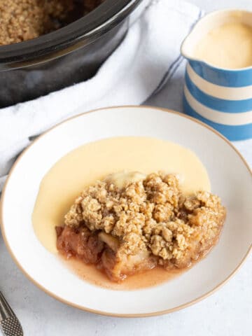 Slow cooker apple crumble with custard.