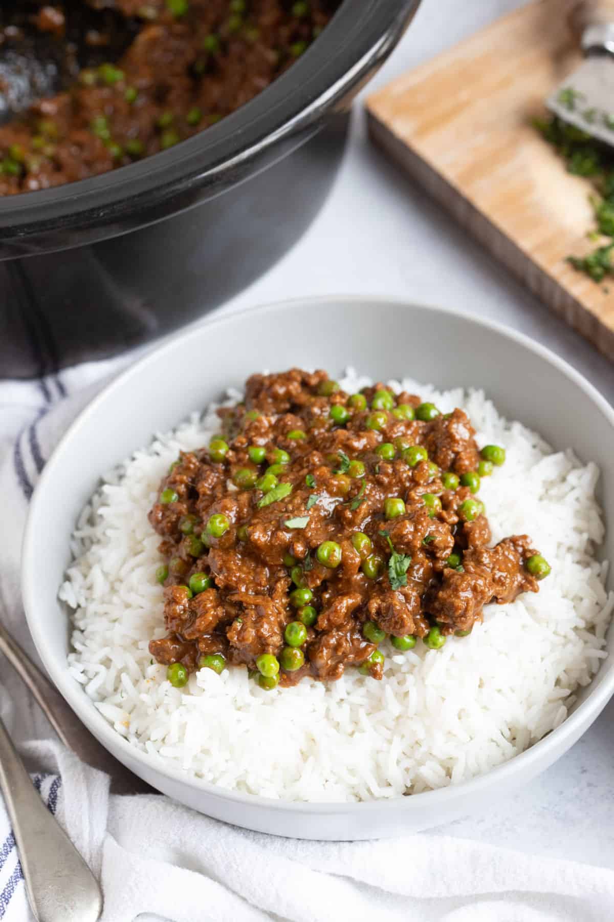 Slow cooker minced beef keema curry in a bowl with rice.