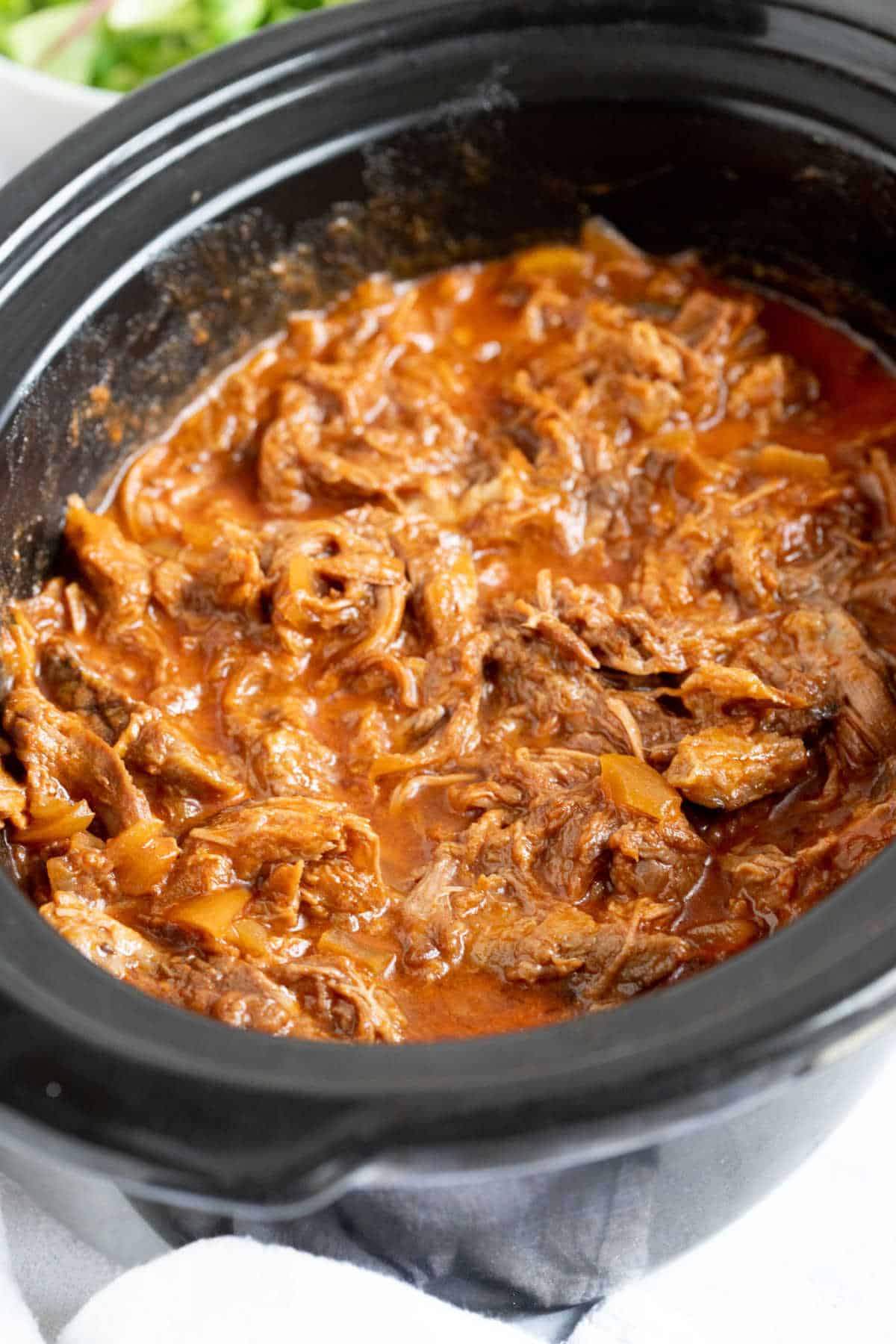 BBQ shredded beef in a slow cooker.