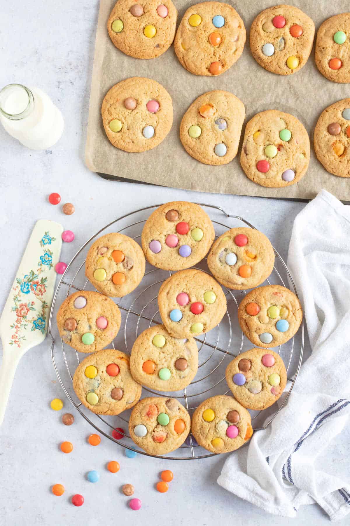 Smarties cookies on a wire cooling rack.