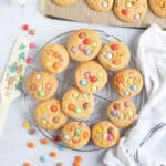 Smarties cookies on a wire cooling rack.