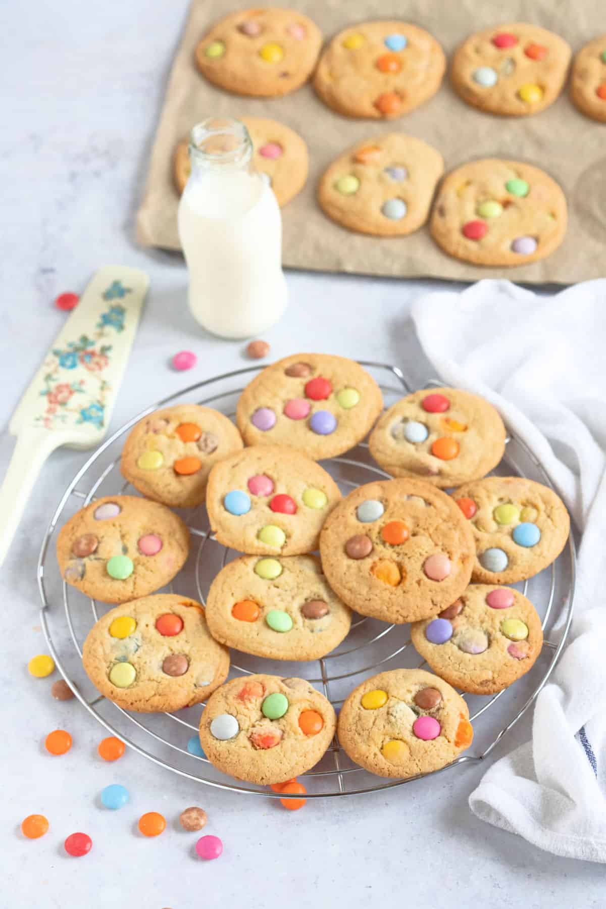 Smarties cookies on a wire cooling rack.