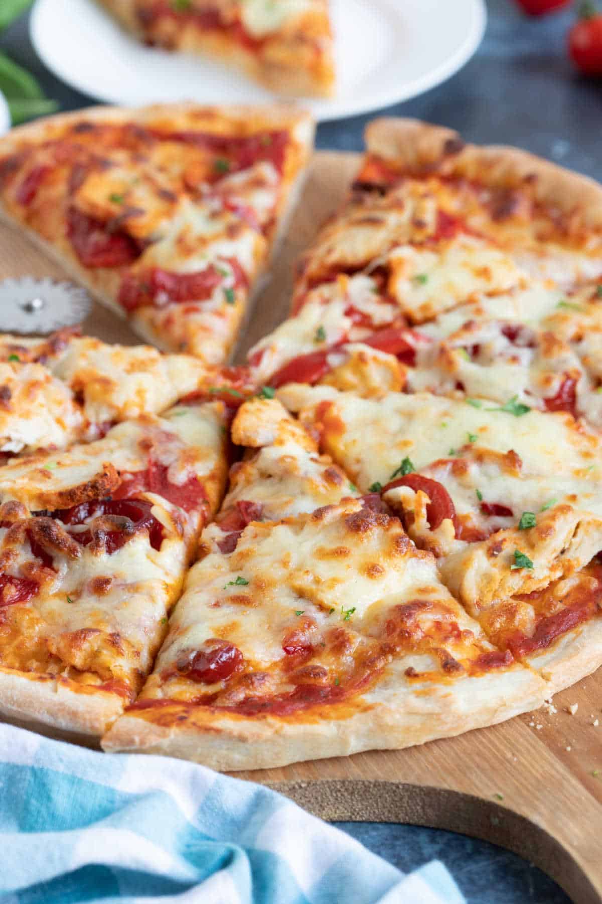 Spicy chicken pizza cut into slices.