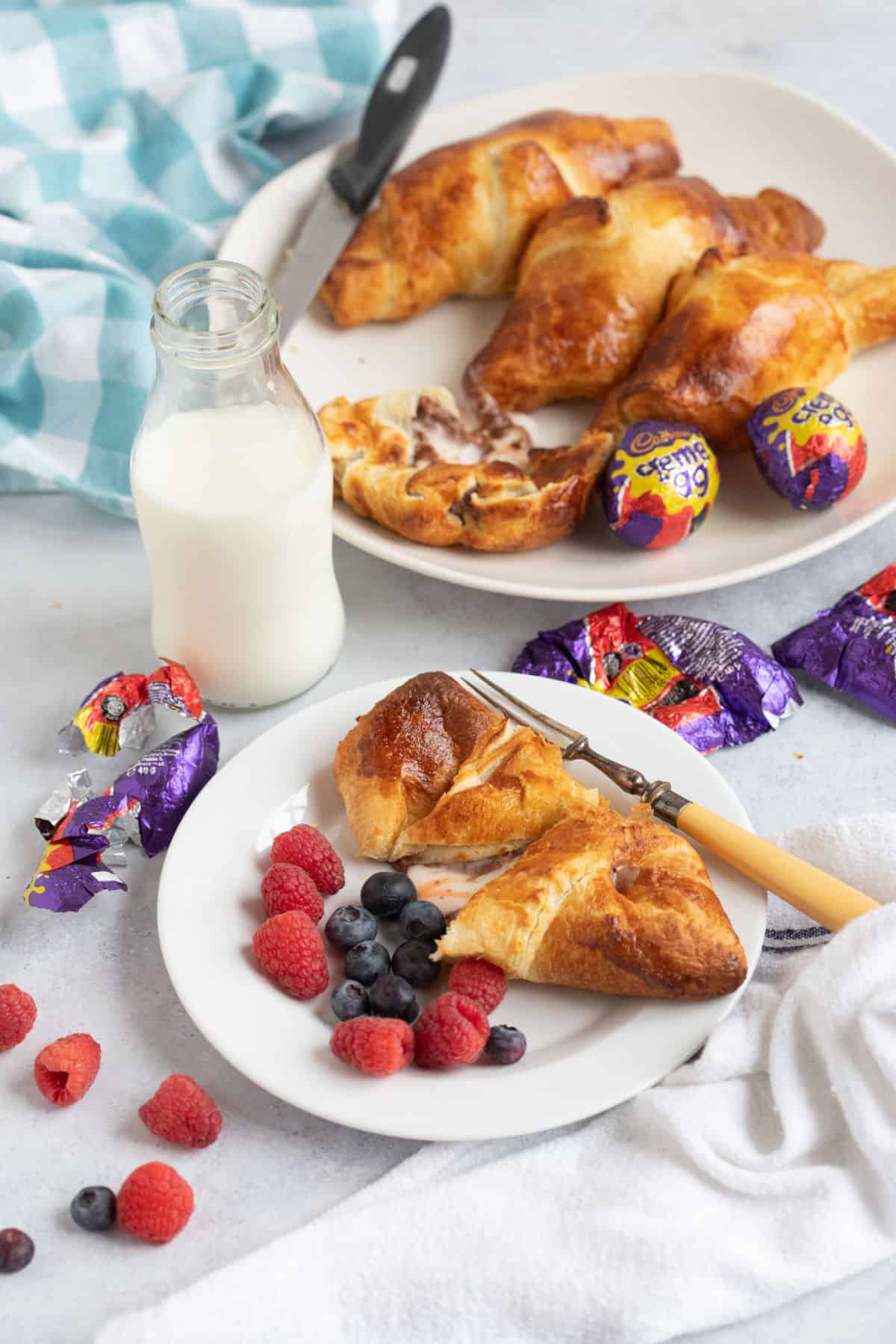 Creme egg croissants with fresh berries and a glass of milk.