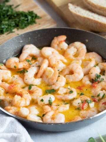 Pil pil prawns in a black dish.