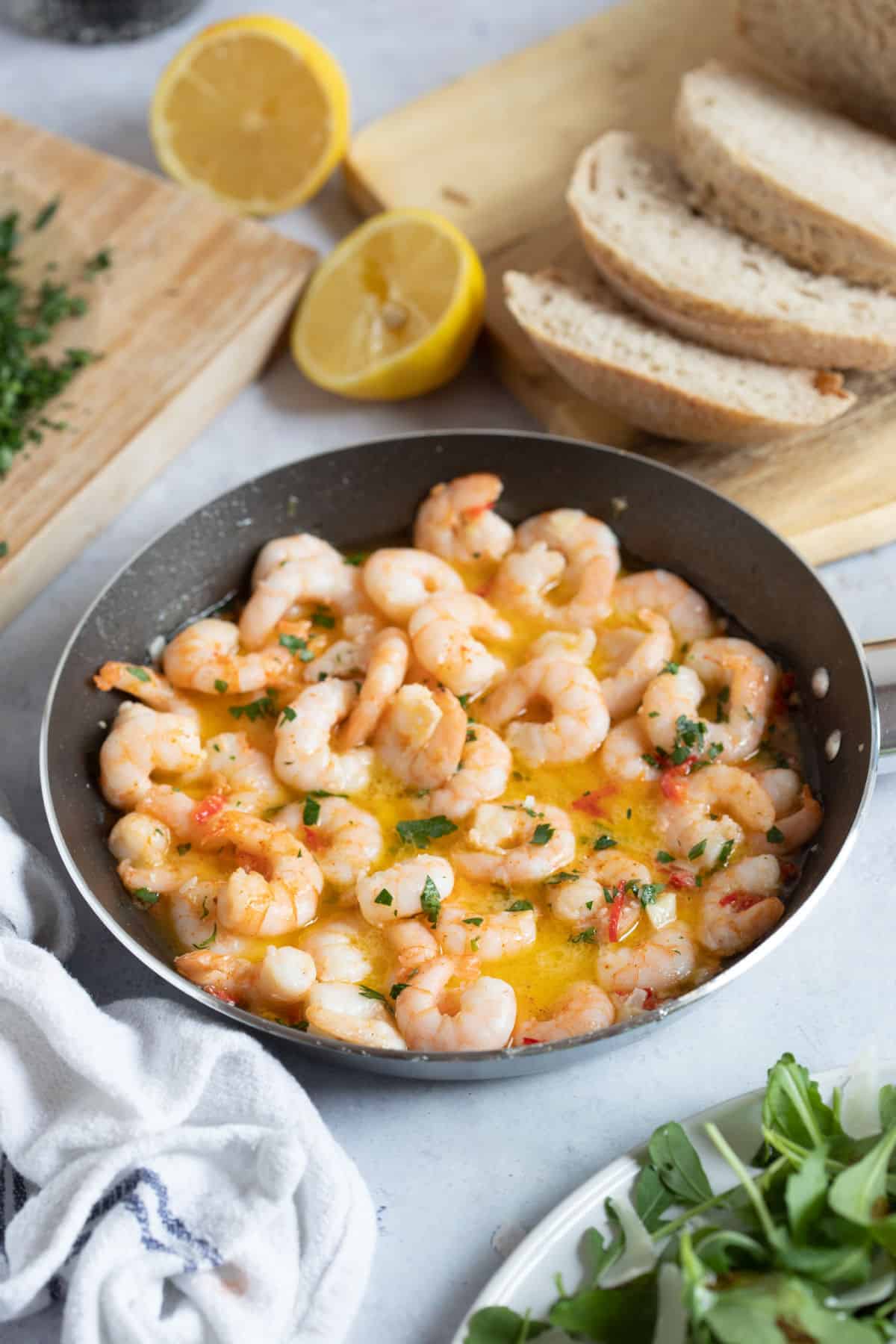 Garlic and chilli prawns with a side of crusty bread.