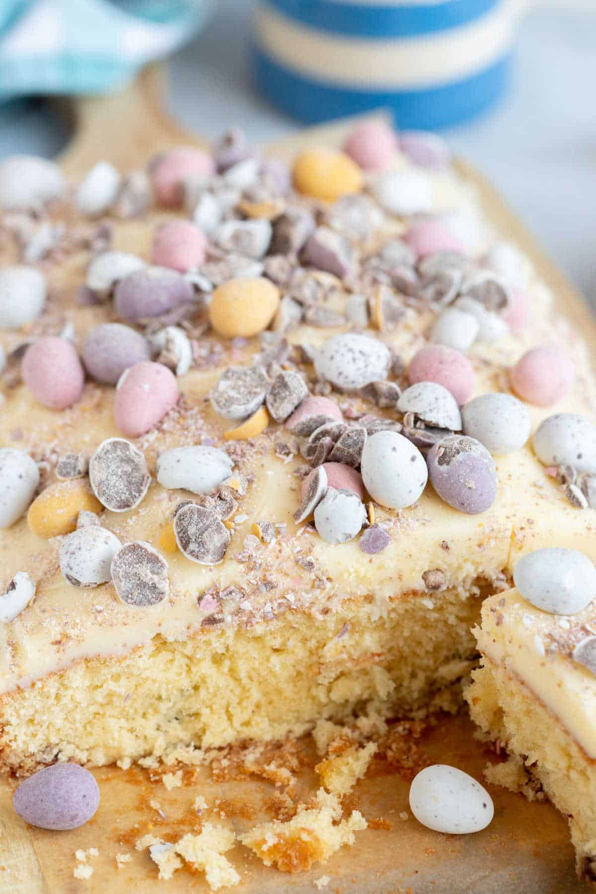 Easter mini egg cake on a wooden cake board.