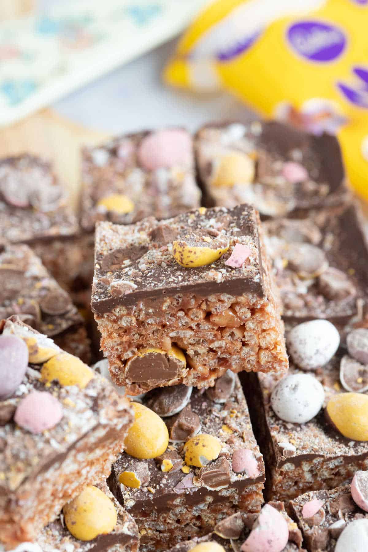 Rice krispie square topped with chocolate and mini eggs.