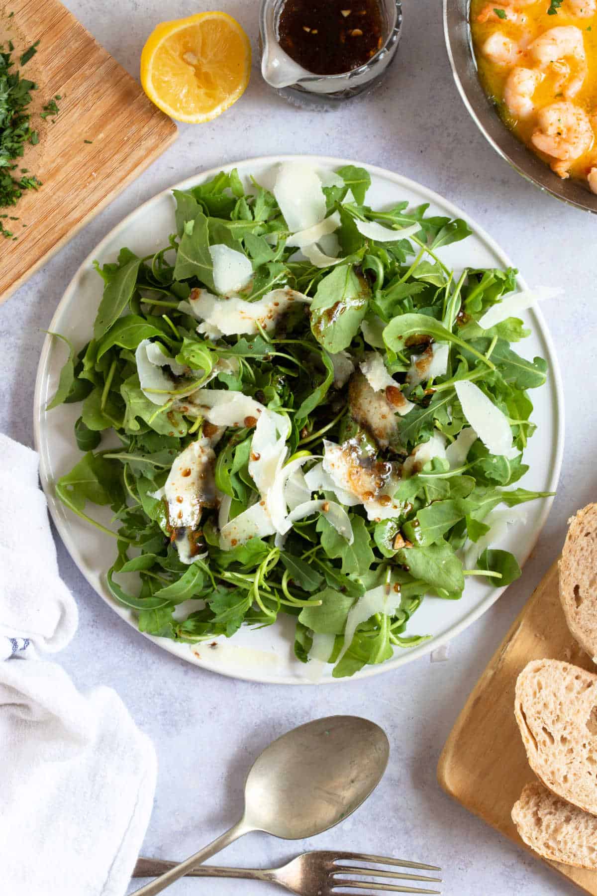 Rocket and Parmesan salad on a white serving platter.