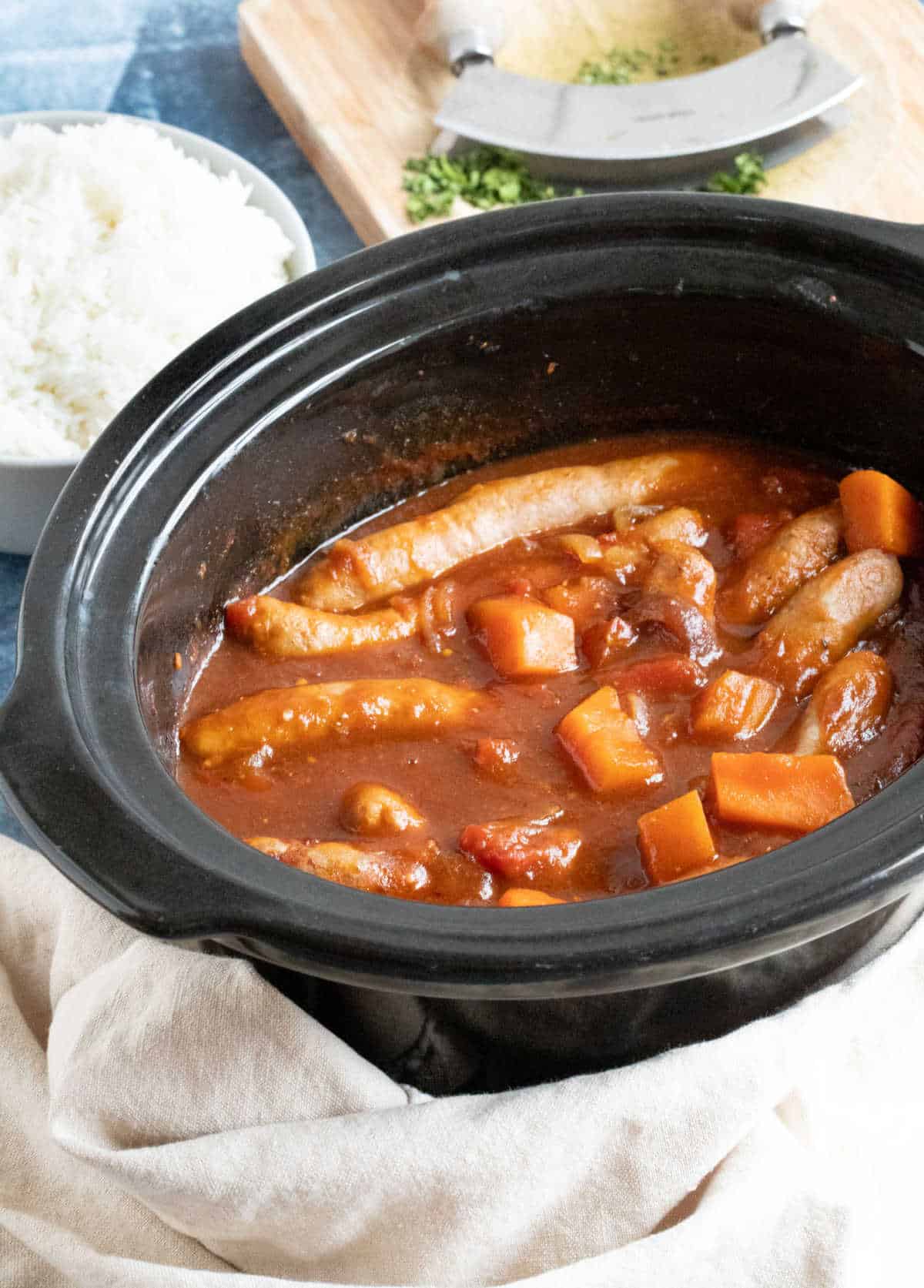 Sausage casserole in a slow cooker basin.