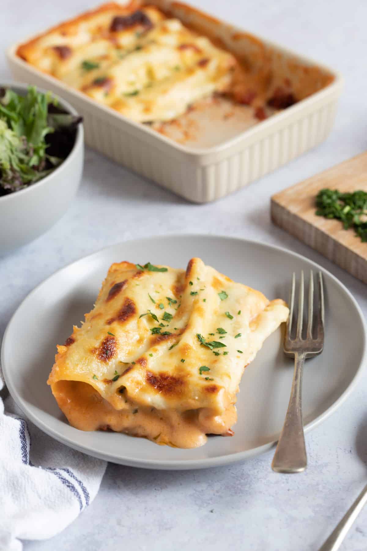 A serving of spinach and ricotta cannelloni on a plate.