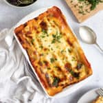 Spinach and ricotta cannelloni in a baking dish.