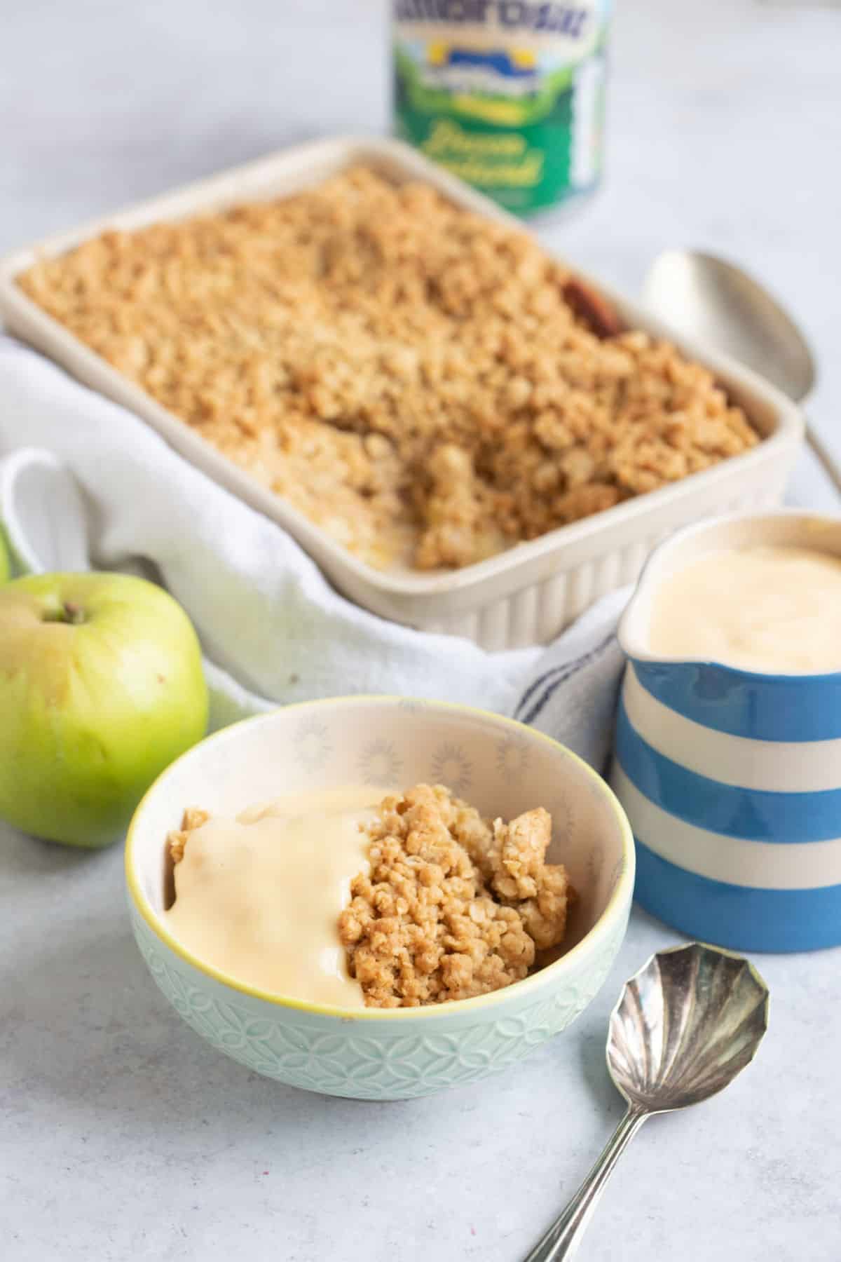 A bowl of apple crumble and custard.