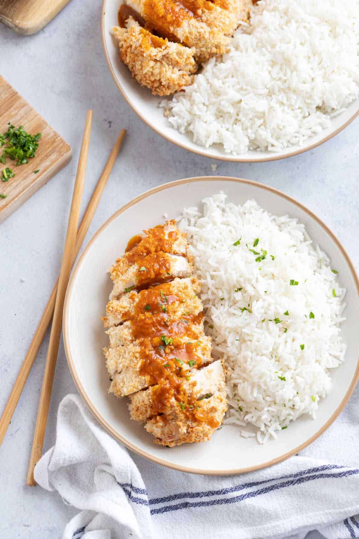 Air fryer chicken katsu with rice on a white plate.