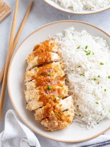 Air fryer chicken katsu with a homemade katsu curry sauce drizzled on top.