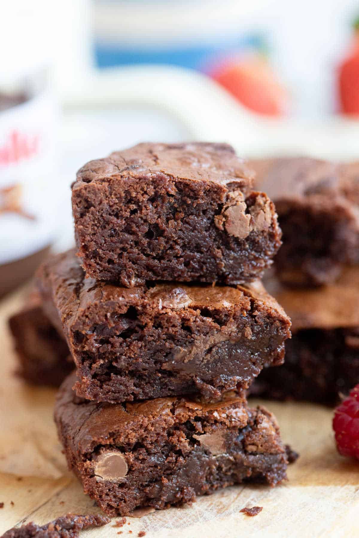 A stack of air fryer chocolate brownies on a wooden board.