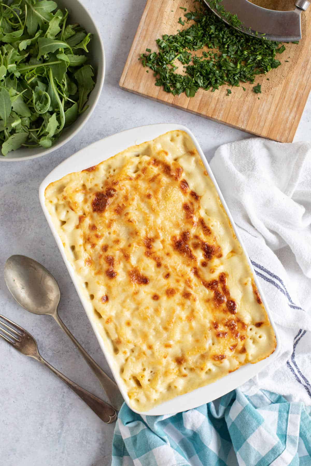 Baked macaroni cheese in a white serving dish.