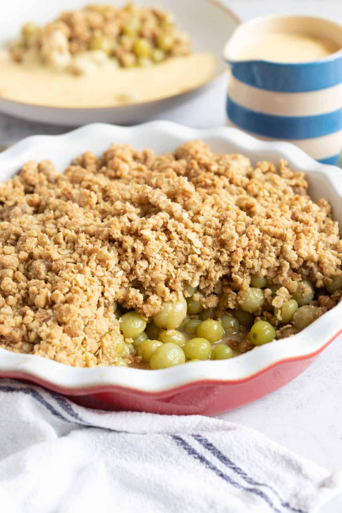 Gooseberries in a oven proof dish with a crumble topping.