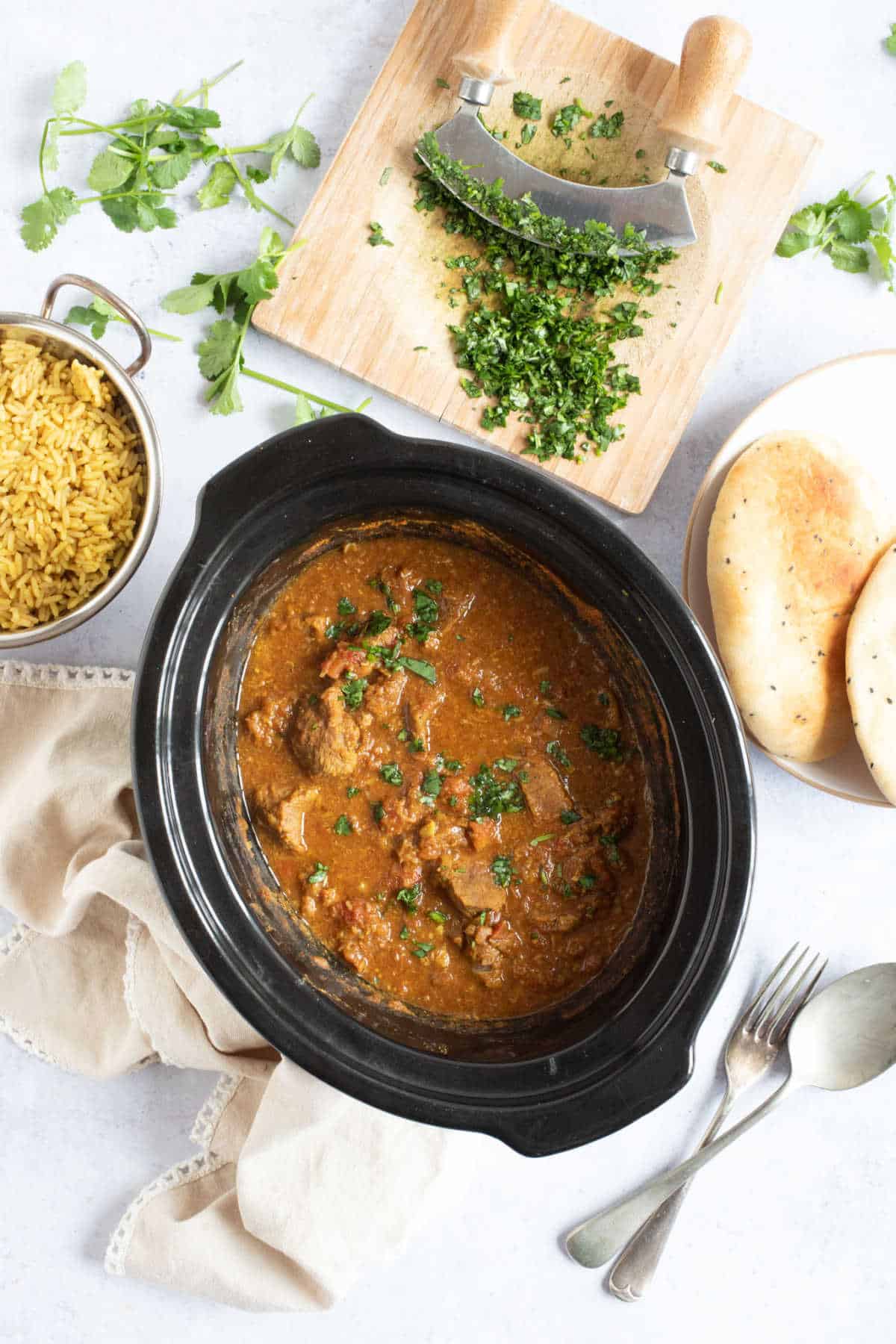 Slow cooker beef curry in a black slow cooker.
