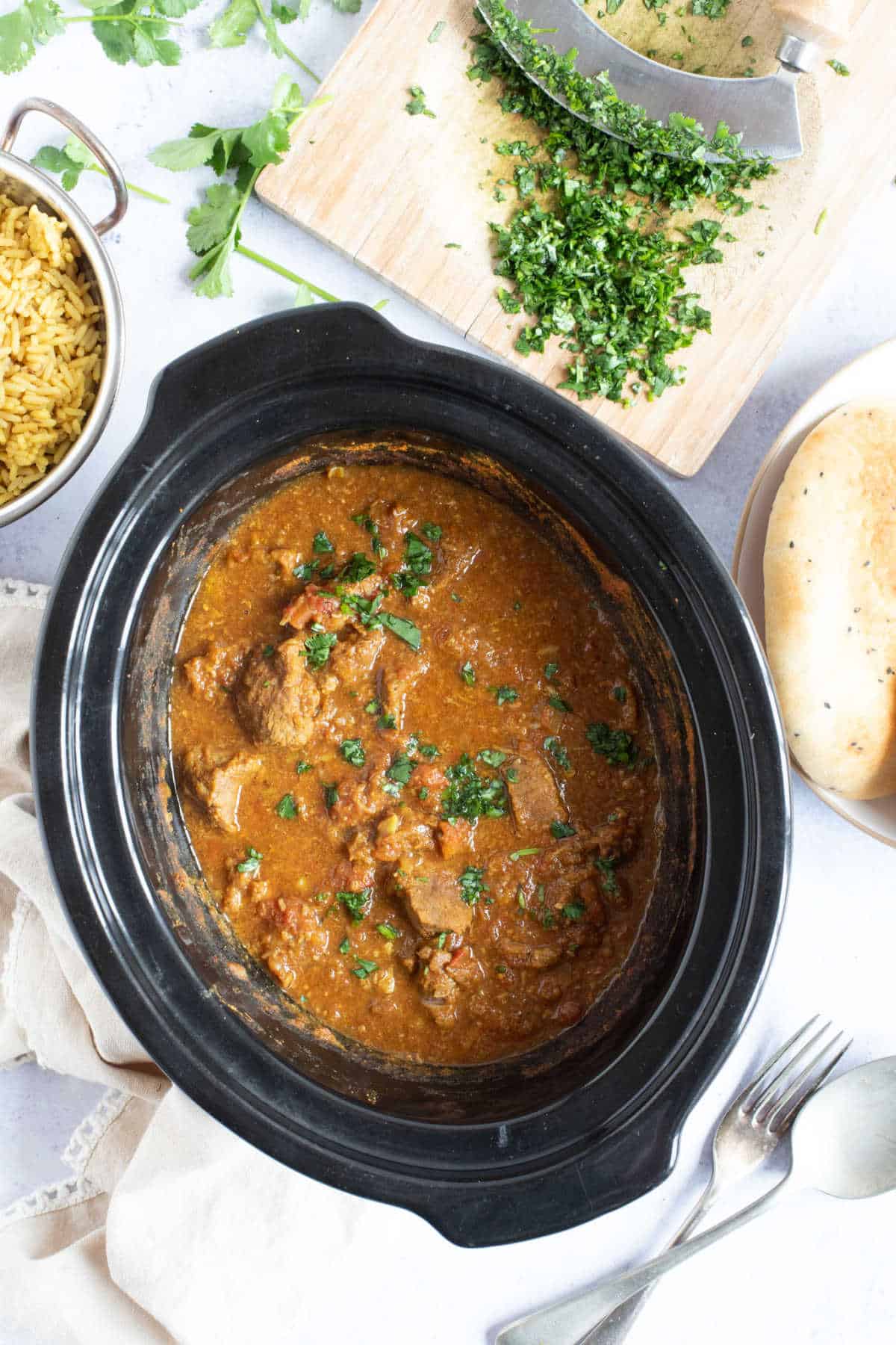 Slow cooker beef curry garnished with coriander.