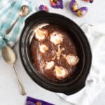 Slow cooker chocolate creme egg pudding in a black crock pot.