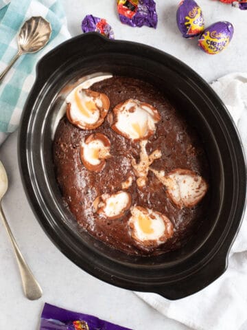 Slow cooker chocolate creme egg pudding in a black crock pot.